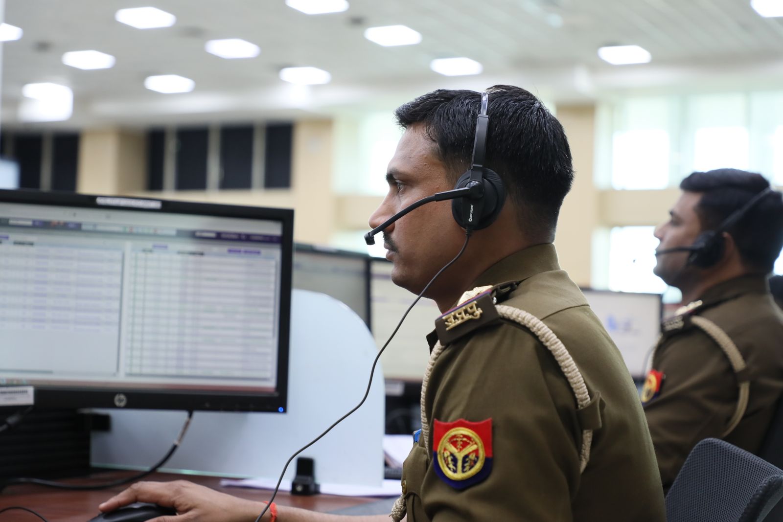 Fleet coordinator reviewing vehicle reporting on screen